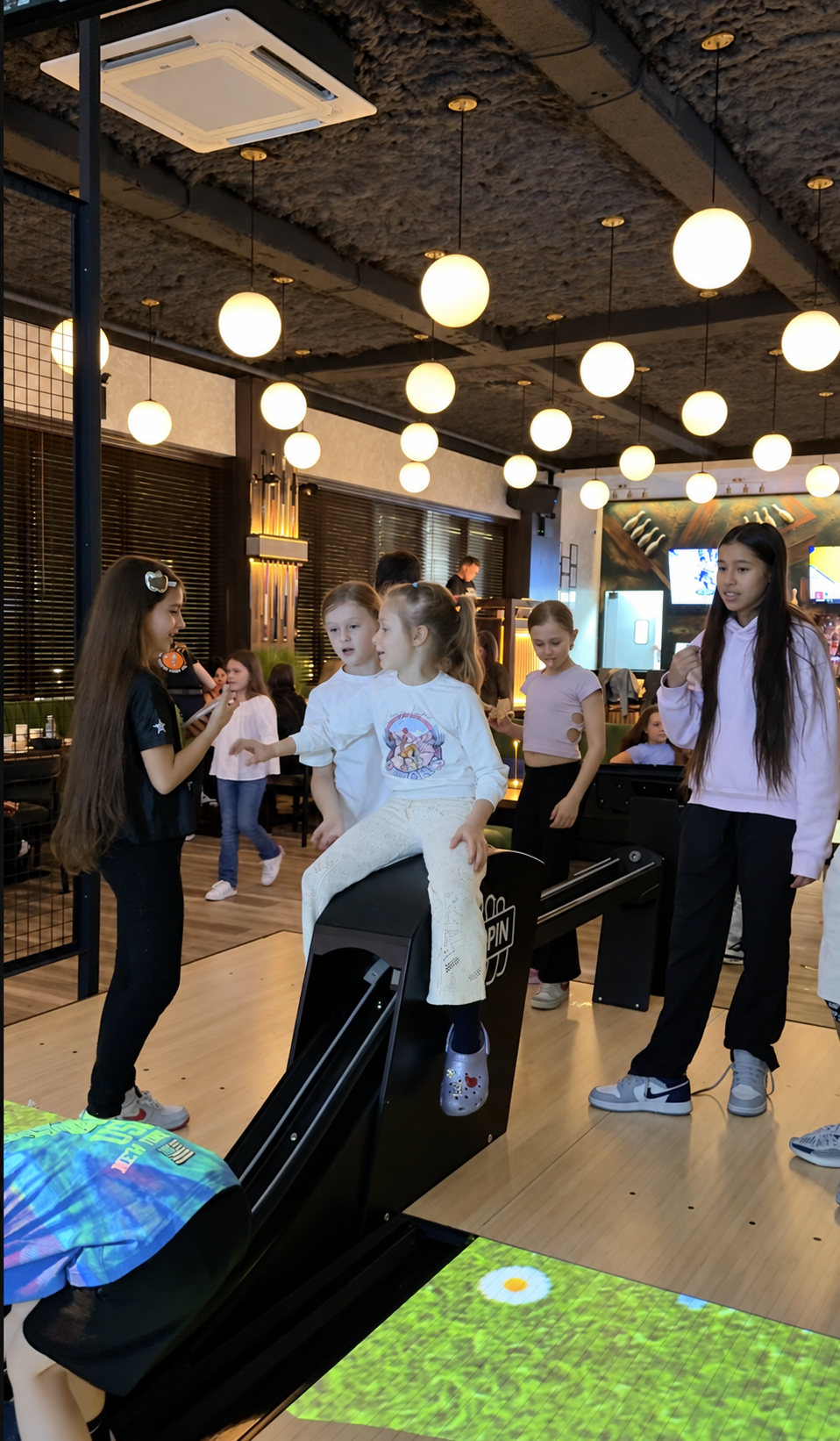 Children spending time together by the bowling lanes