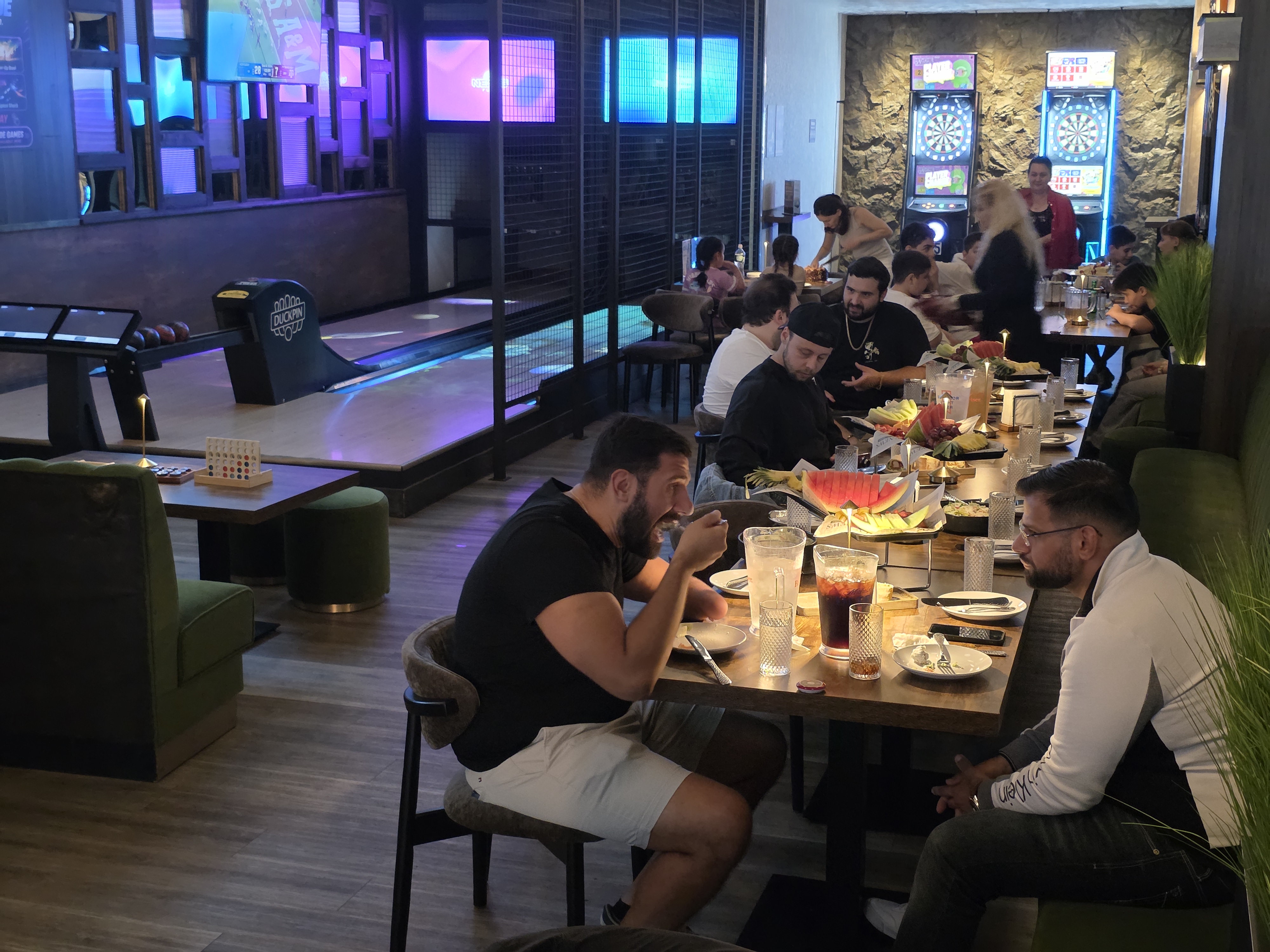 Guests dining beside mini bowling and darts at SET